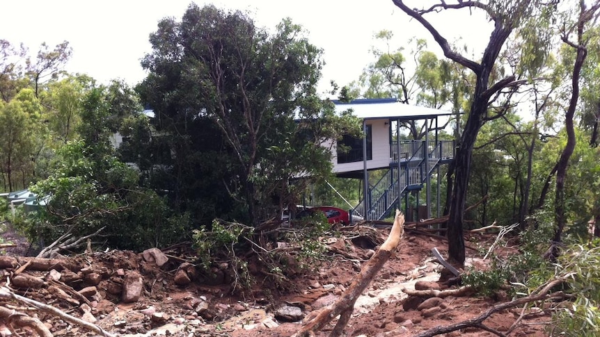 Mudslide threatens a house at Hideaway Bay on March 31.