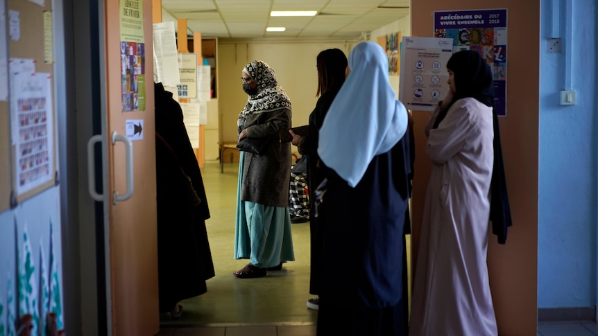 Women wait in line before french election