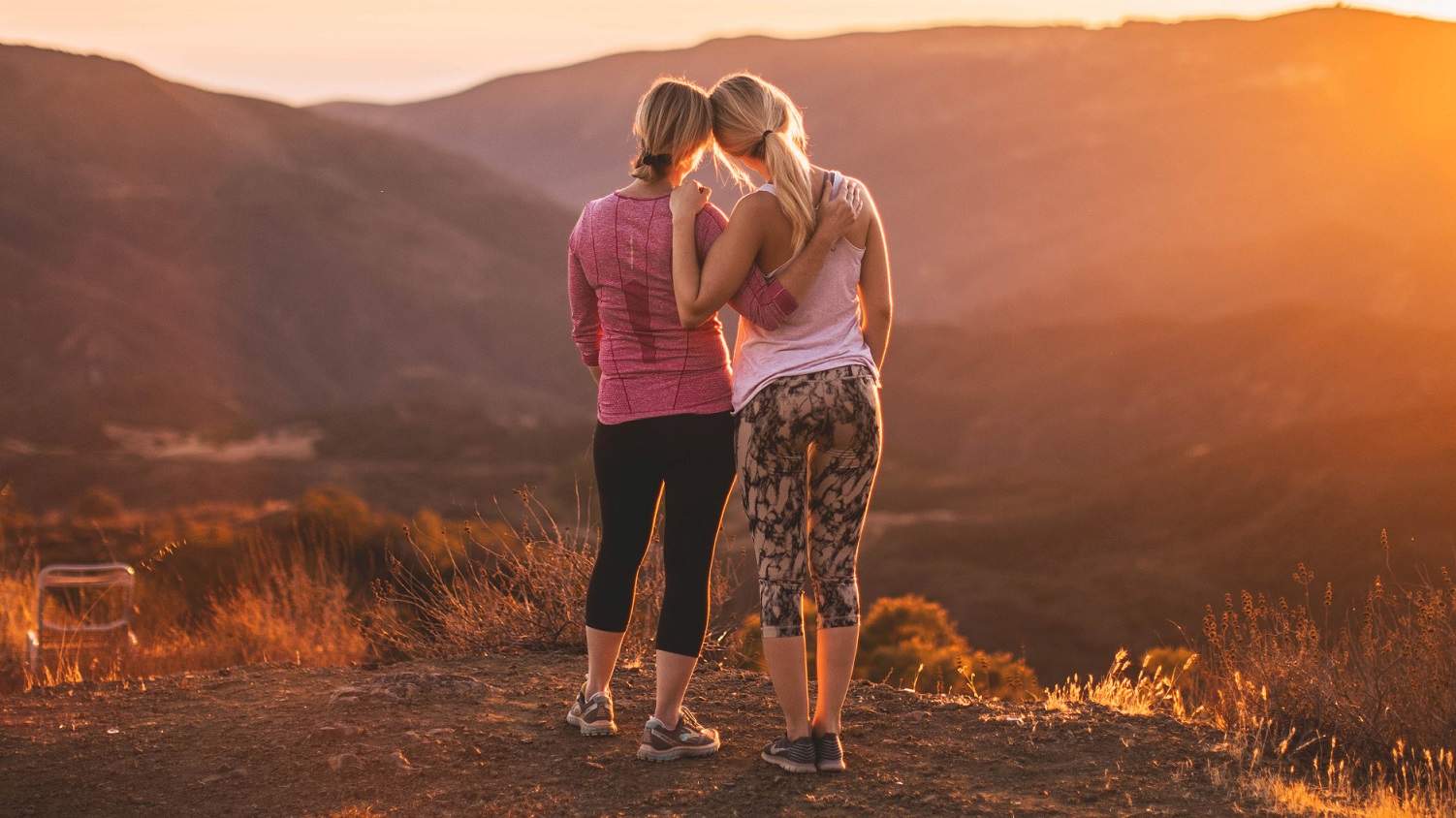 Two woman stand shoulder to shoulder for a story about the importance of girls having aunties/older women role models