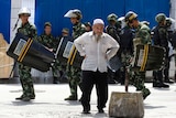 Uyghur man and soldiers