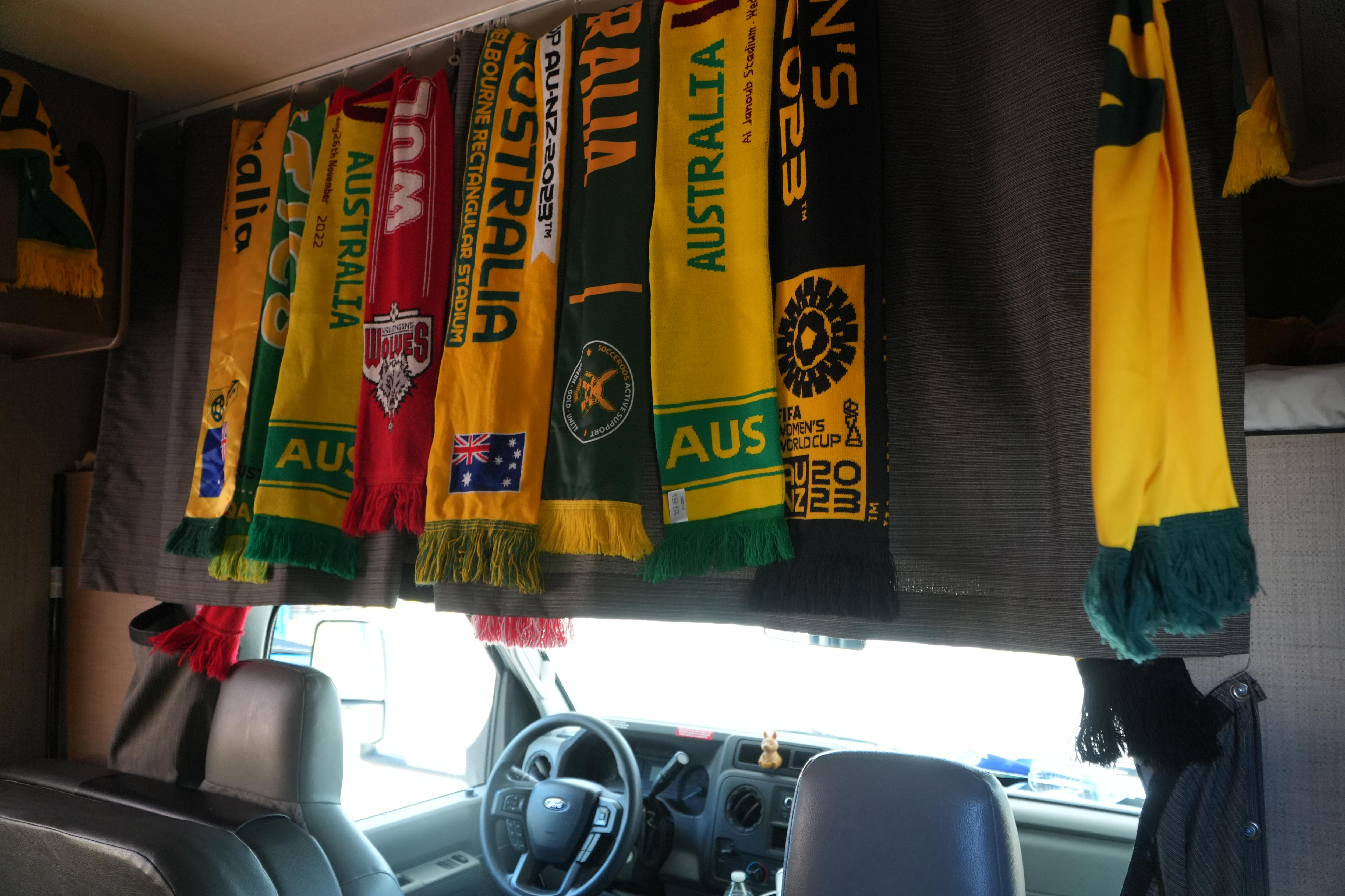 A row of Australia green and gold scarves hanging inside an RV
