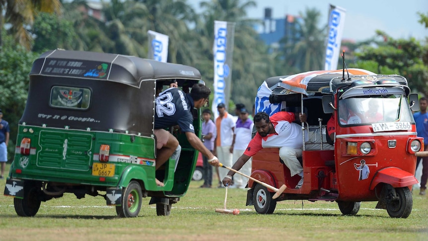 The tuk-tuks are controlled by local drivers, while players concentrate on wielding the polo sticks.