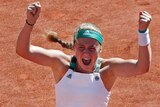 Jelena Ostapenko celebrates after winning the French Open, beating Simona Halep