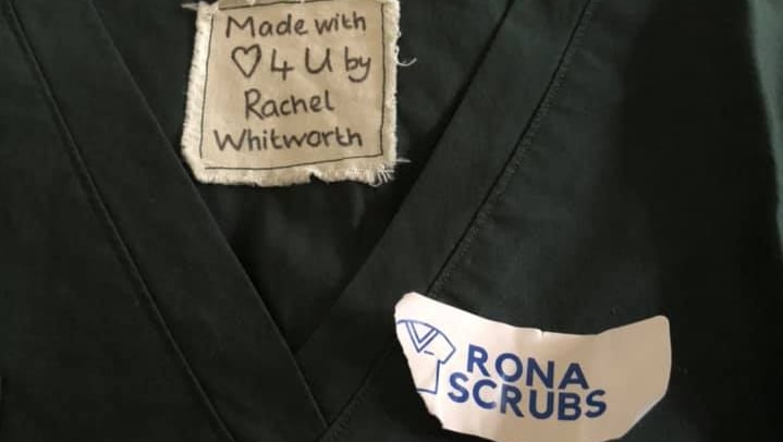 A set of scrubs with a tag that reads Made with Love 4 U by Rachel Whitworth