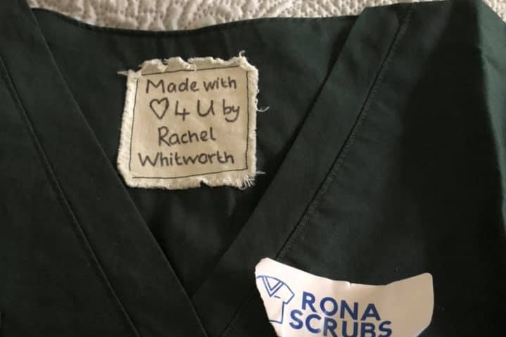 A set of scrubs with a tag that reads Made with Love 4 U by Rachel Whitworth