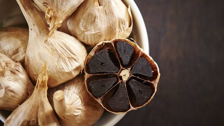 Photo of a black garlic bulb.