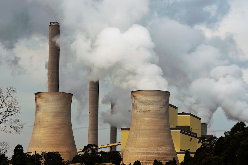 Power station towers with smoke billowing