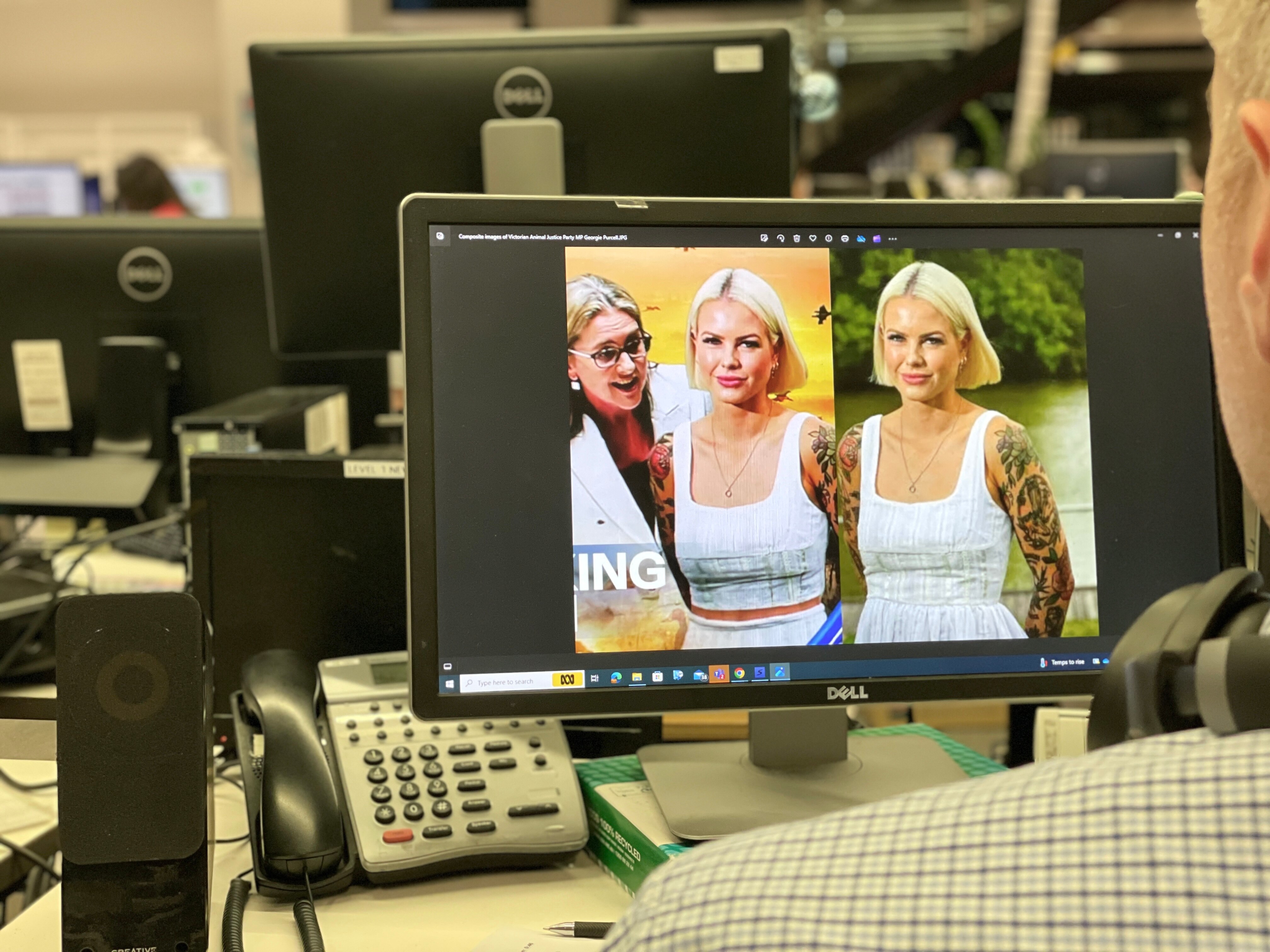 A view over a person's shoulder as they look at a digitally altered image of a politician.