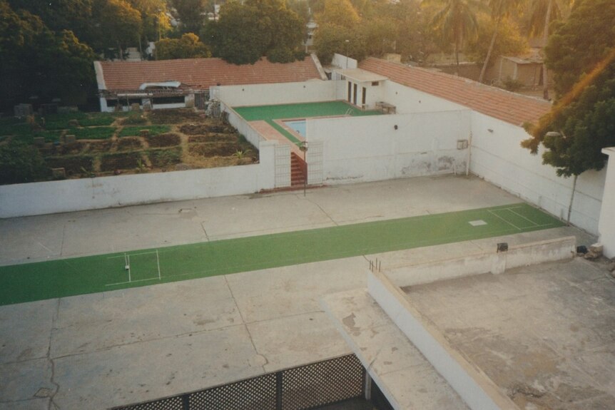 photo of backyard synthetic pitch and net as well as pool and gardens