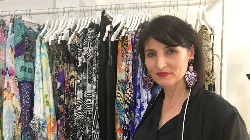 Clothing retailer Sylvia Majetic in front of a rack of clothes in one of her shops in Darwin.