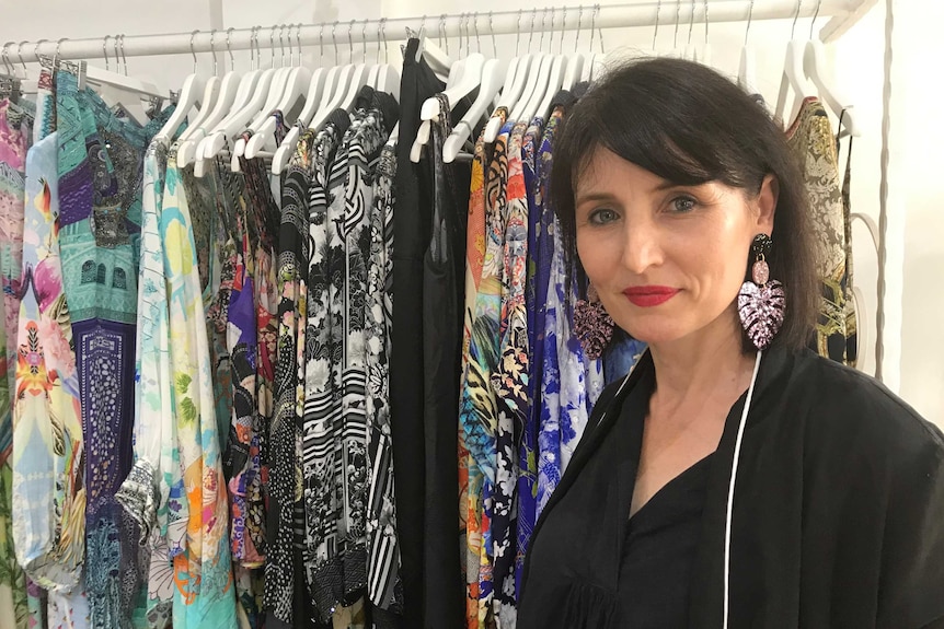 Clothing retailer Sylvia Majetic in front of a rack of clothes in one of her shops in Darwin.