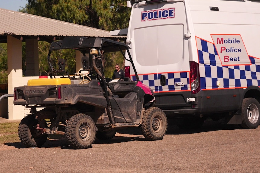 A all-terrain buggy parked behind a police van