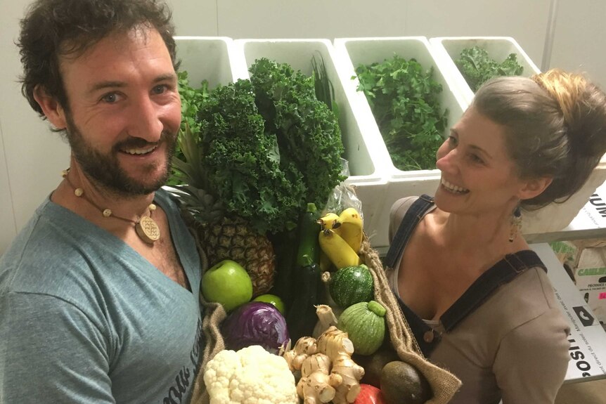 Ben and Georgie McKeown with a box full of fresh produce.