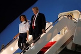 US President Donald Trump arrives back on home soil, but there is no warm welcome.