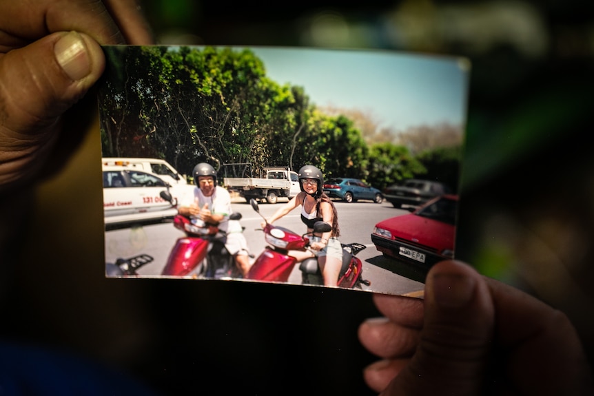 Andrew holds a picture of himself with his wife Suzy.