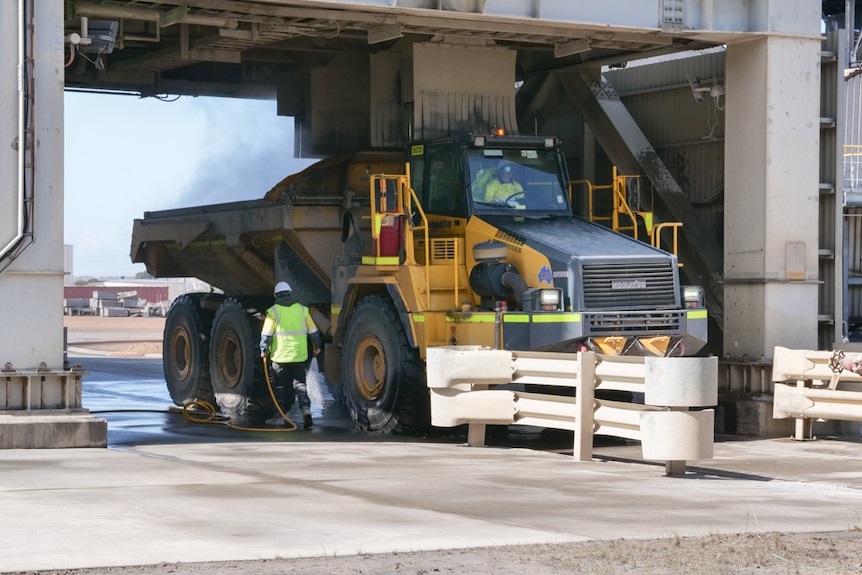 A truck collecting a dust product from the bottom of a silo 