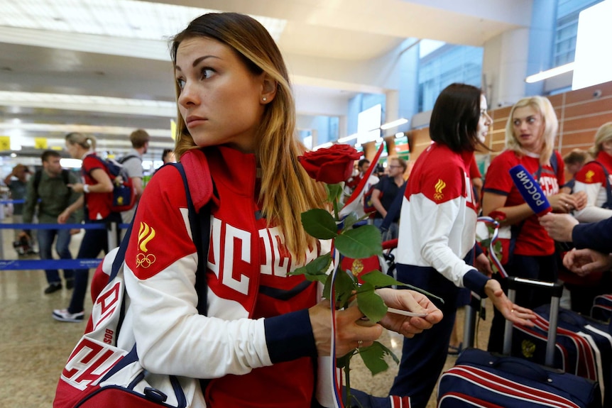 Marina Sudakova looks on in departure lounge prior to Rio 2016 Olympics