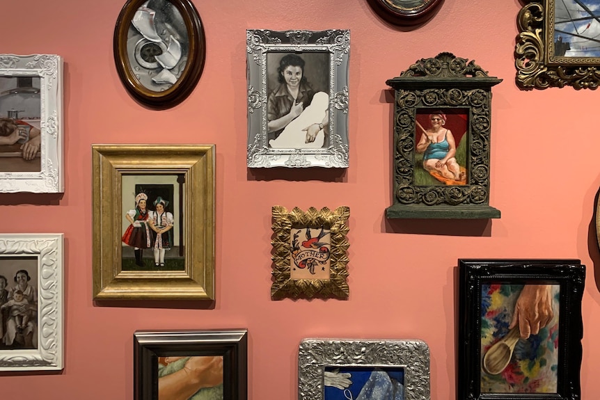 Wall of picture frames depicting mothers in different scenes 