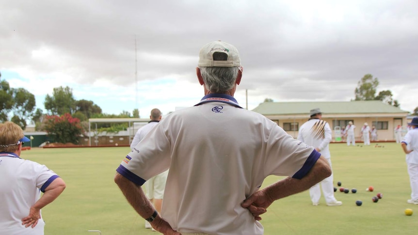 A Mundoora bowls player looks out onto the green.