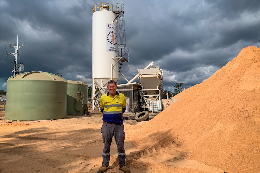 Glen Smith standing at a mine with clouds overhead.