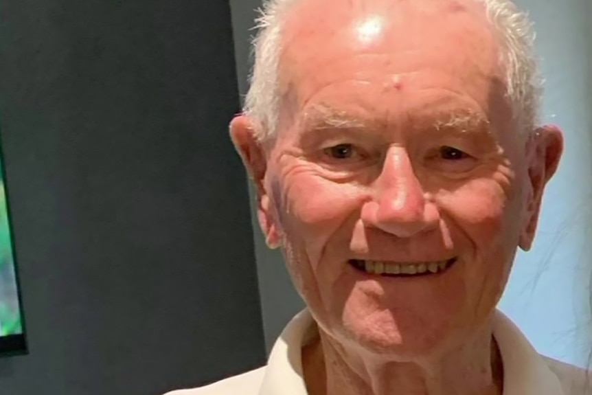 A close-up shot of an elderly man smiling.