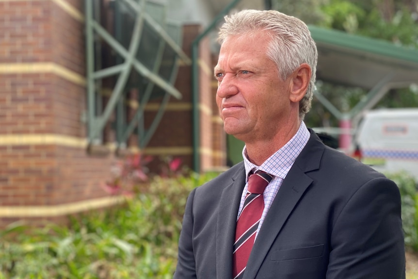 Man standing in suit looking into the distance