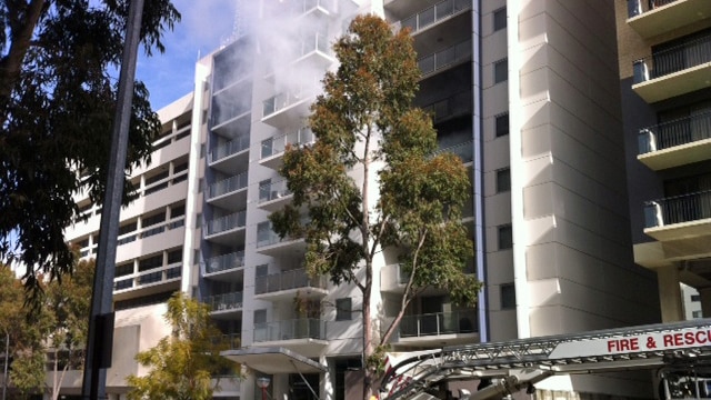 Smoke comes out of apartment in Hay Street high rise