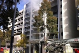 Smoke comes out of apartment in Hay Street high rise