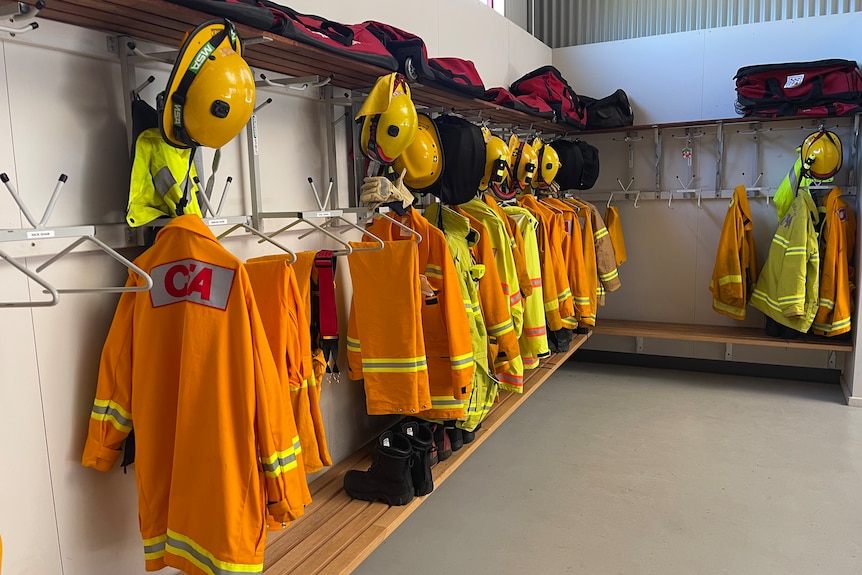 The CFA uniforms are yellow and hanging along the inside wall of the garage. There are also yellow CFA helmets.