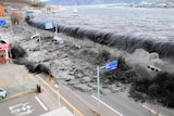 A wave approaches Miyako City from the Heigawa estuary in Iwate Prefecture after the magnitude 8.9 earthquake in March 2011At least