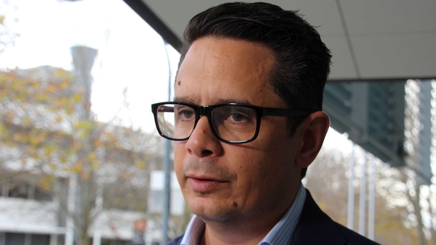 Head and shoulders shot of WA Treasurer Ben Wyatt wearing glasses.