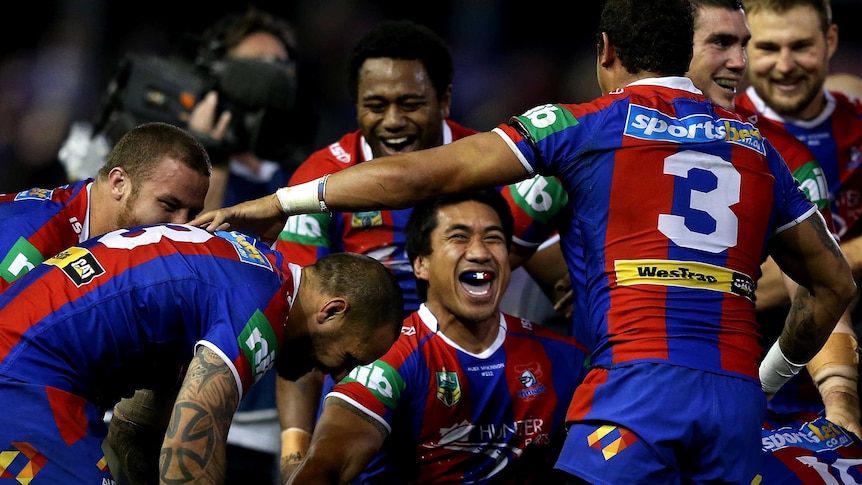 Knights players celebrate after the winning conversion kick against the Storm.