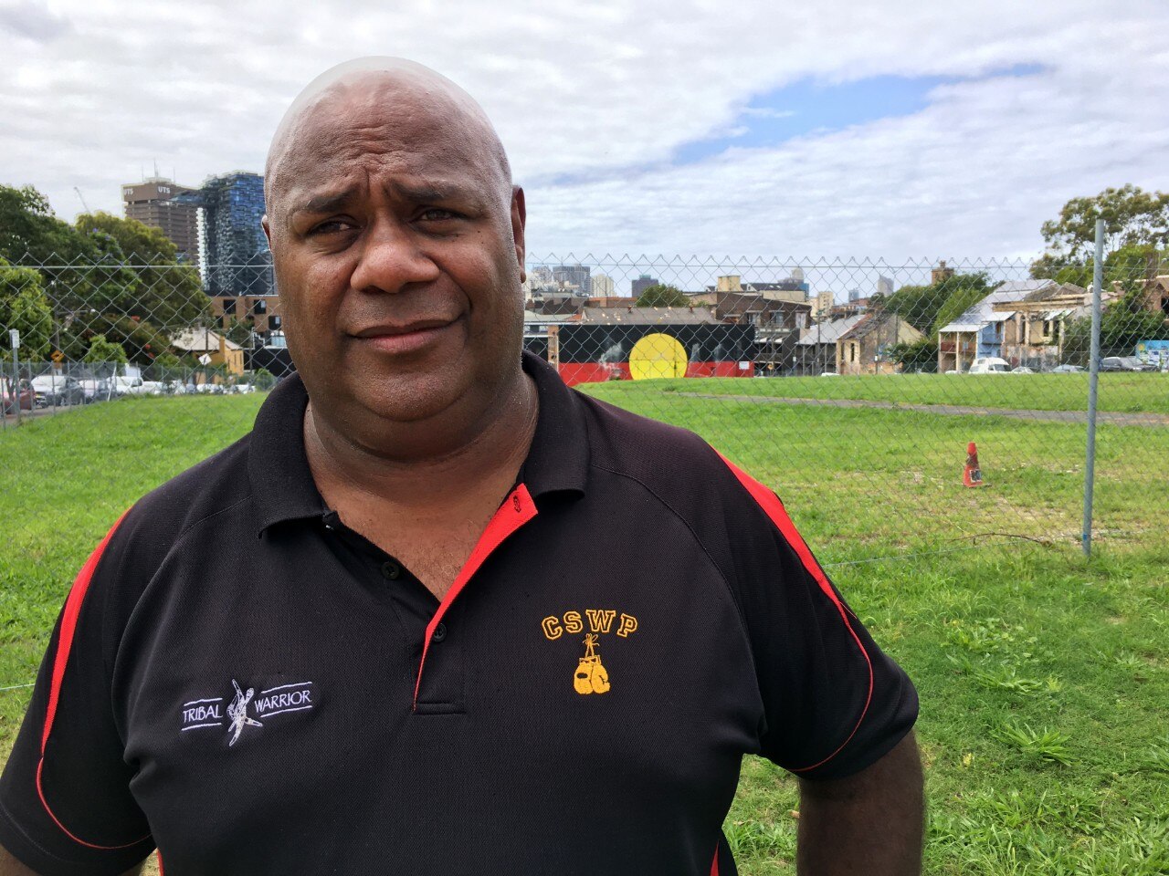 A man stands in front of Redfern's The Block.
