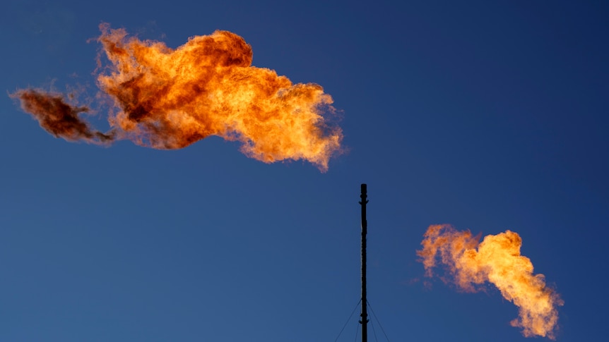 Flares burn off methane and other hydrocarbons at an oil and gas facility in Lenorah, Texas