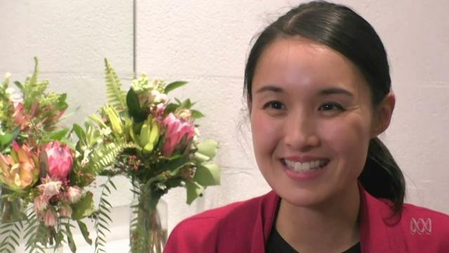 Author Alice Pung sits beside flowers
