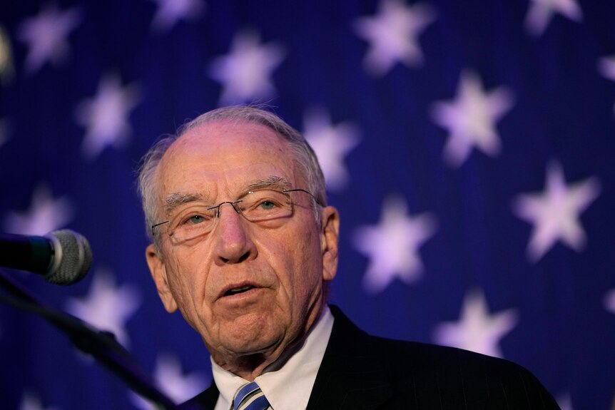 Chuck Grassley standing in front of a microphone. 