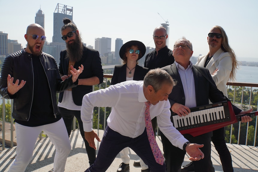 A band gathers on the viewing platform at Kings Park with politicians posing theatrically. 