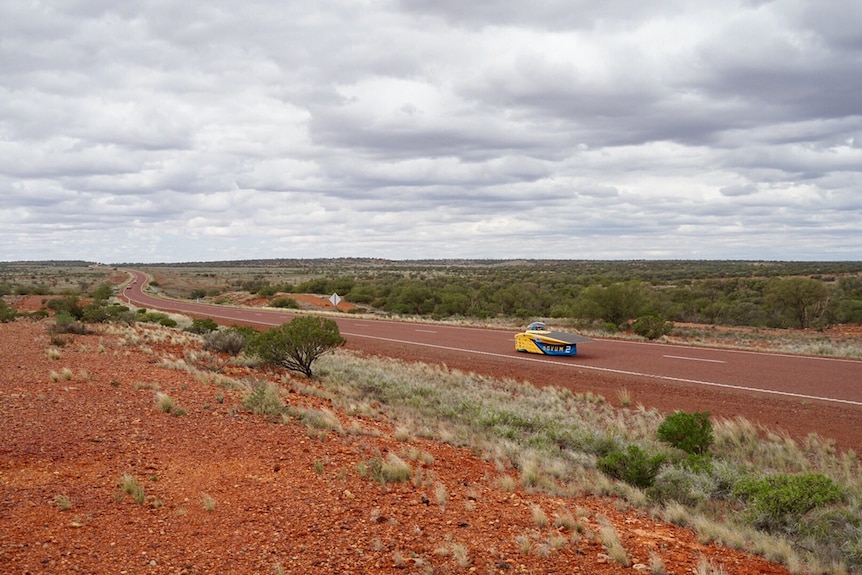 The University of Michigan drives its solar car along the Stuart Highway during cloudy conditions.