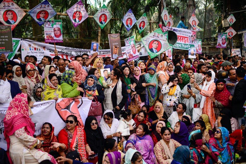 Bangladesh women sitting and standing in a group protesting ahead of election.
