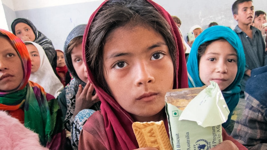 A young girl receives Australian food aid in Afghanistan's Jawzjan province.