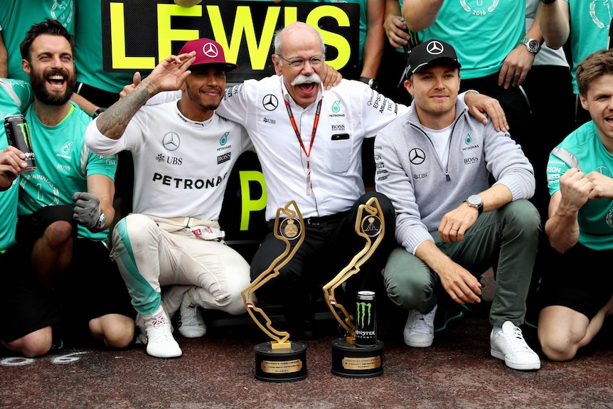 Lewis Hamilton and Nico Rosberg with their Mercedes team after the Monaco GP
