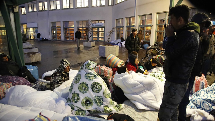 Asylum seekers sleep on the ground outside the entrance to Sweden's Migration Agency.