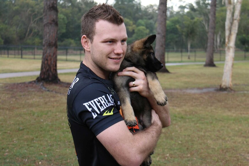 Jeff Horn smiles for a photo with Hornet the police dog