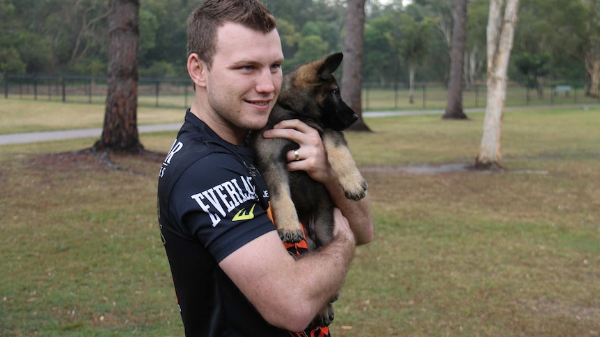 Jeff Horn smiles for a photo with Hornet the police dog