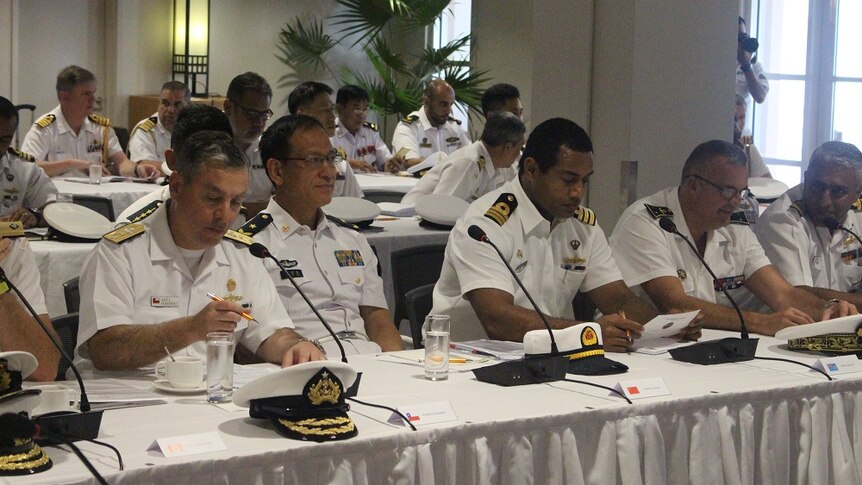 Navy admirals and senior officials sit during the presentation