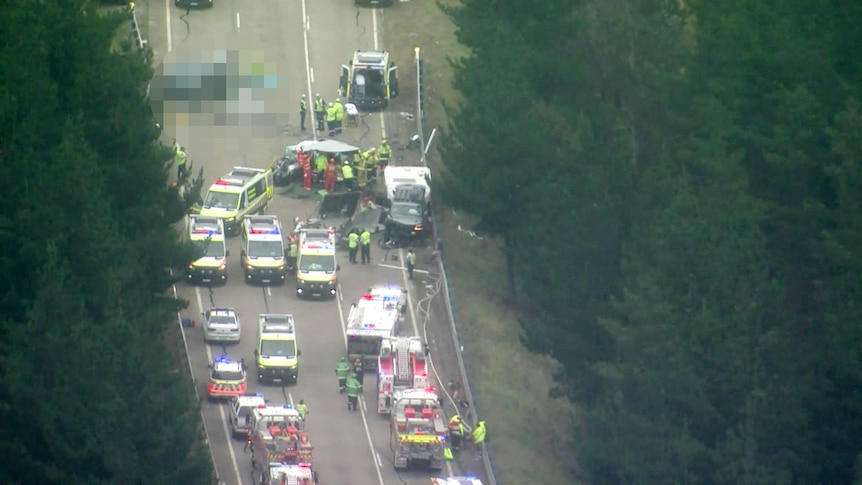 Birds eye view of several emergency services with lights on at the scene of a major crash