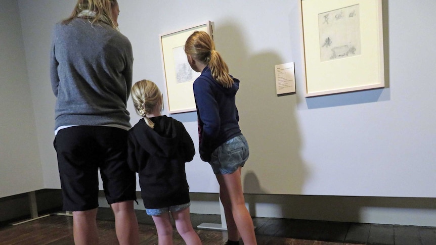 A family looks at Winnie the Pooh exhibition
