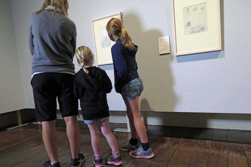 A family looks at Winnie the Pooh exhibition