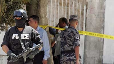 Jordanian policemen secure the area of the attack.