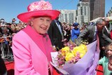 The Queen accepts flowers from well-wishers in Melbourne's Federation Square.